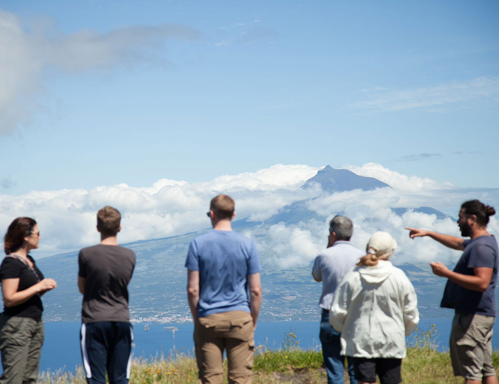 car tour in group of men looking at a volcano