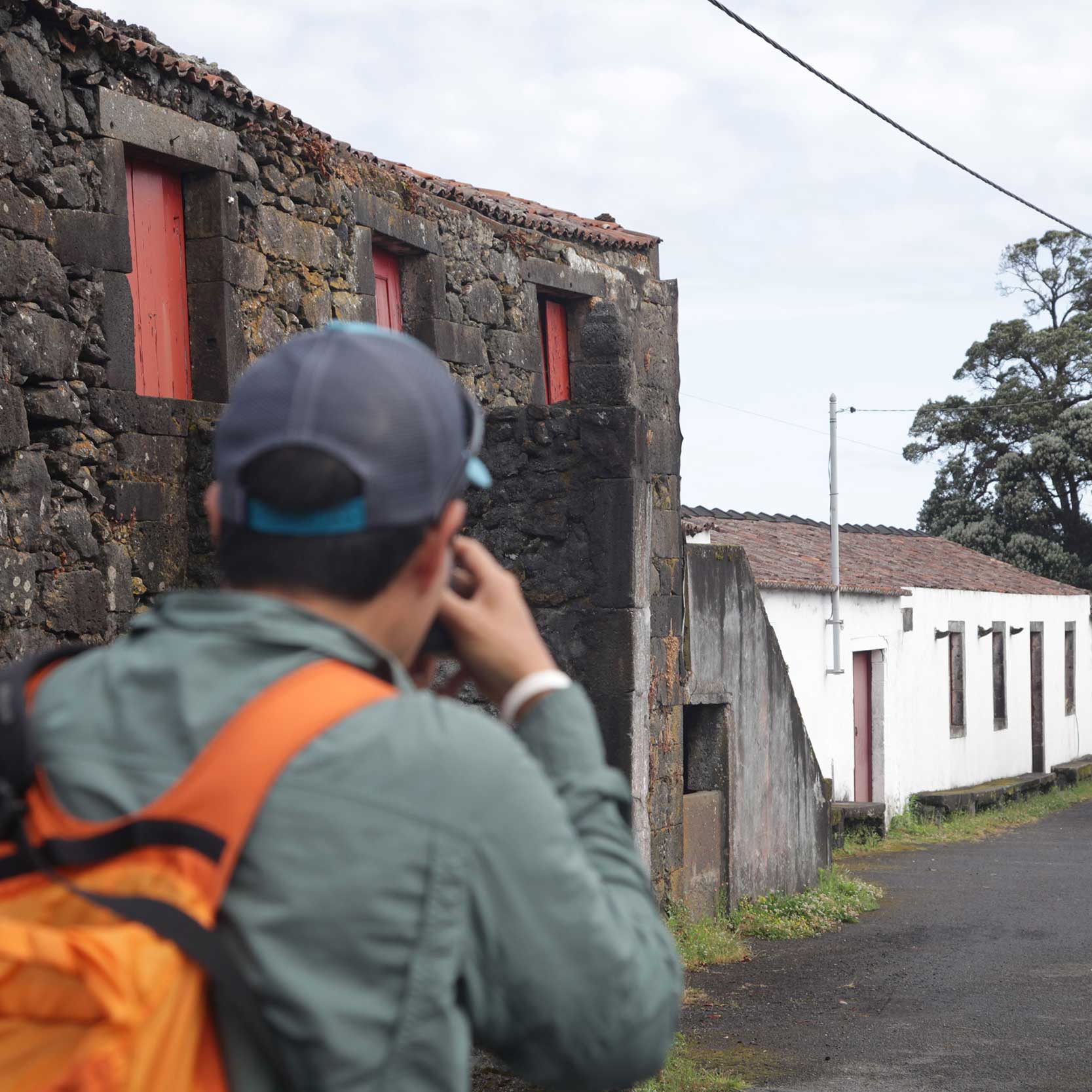 Customer photographing an old traditional architecture house. Faial half day includes the main attractions